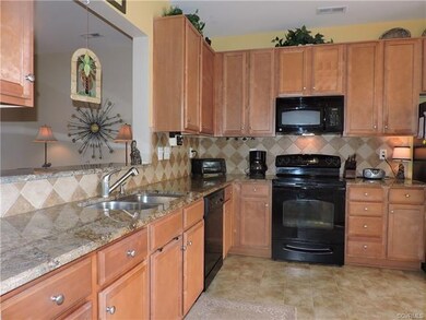 Kitchen includes granite counter tops, tile backsp
