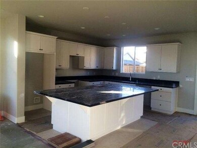 Large kitchen with white cabinets, quartz counters