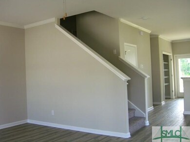 STAIRWAY ACROSS FRON DINING ROOM LEADING TO 2ND FL