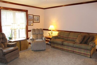 Large living room with newer carpeting, chair rail