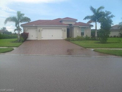 View of front of house with a front yard and a gar