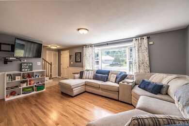 This spacious living room has cool gray walls, a h