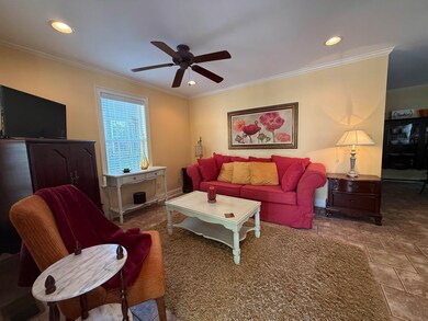 Living area featuring crown molding, recessed ligh