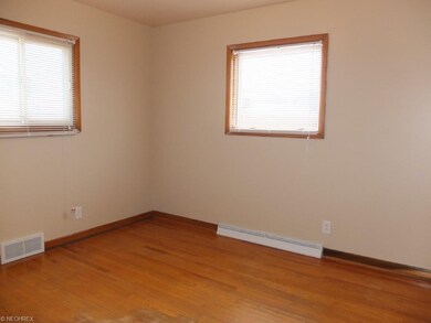 Bedroom 2 with wood flooring.