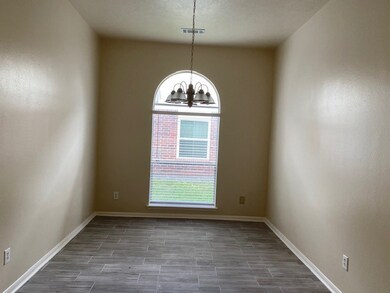 Charming dining area with an arched window, ideal