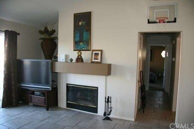 Living room, showing fireplace and hallway.