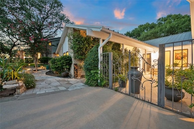 View of home's exterior featuring a metal roof and a gate