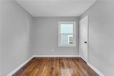 Unfurnished room featuring dark hardwood / wood-style floors