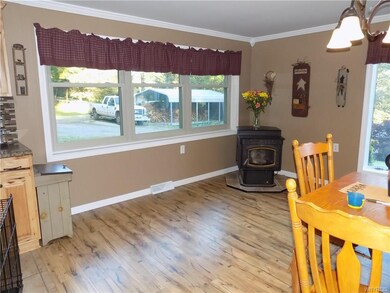 The kitchen/dinette area has a pellet stove and up