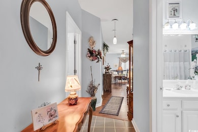 Hallway with sink and light tile patterned floors