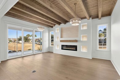 Unfurnished living room featuring beamed ceiling, 