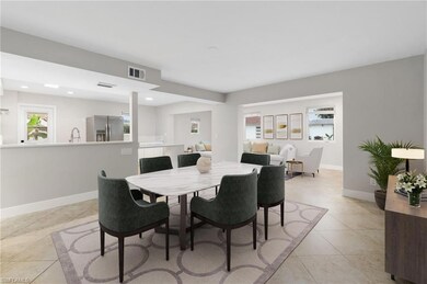 Dining area featuring sink and light tile patterne