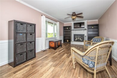 Family room has newer ceiling fan and laminate flo