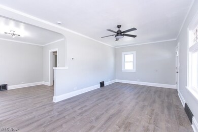 Spare room with ceiling fan, hardwood / wood-style floors, and crown molding