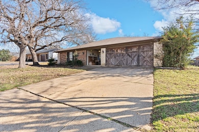Single story home featuring an attached garage, br