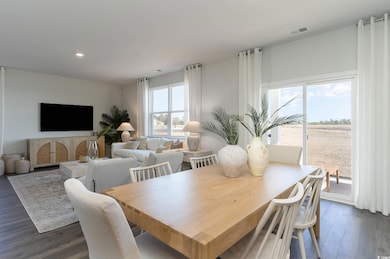 Dining room featuring visible vents, recessed lighting, and dark wood-style floors