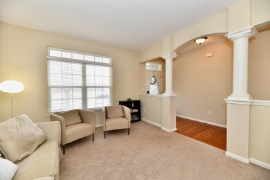 Architectural detail with arched column and entry to living room