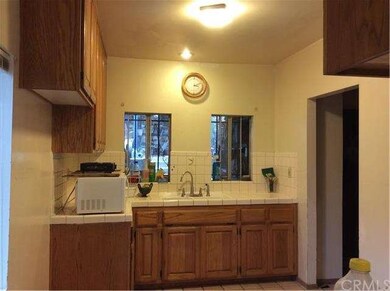 Newer Oak cabinets and ceramic tile in kitchen.
