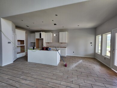 WHITE CABINETRY IN SPACIOUS KITCHEN AREA