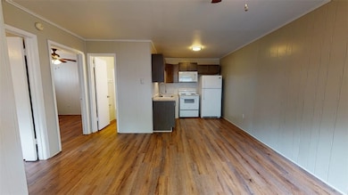 Kitchen with white appliances, light countertops,