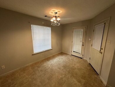 Unfurnished dining area with a textured ceiling and a chandelier