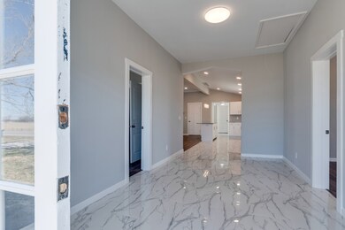 10x18 Entry Foyer has a wonderful amount of Natural light. The front of the home faces West. You could sit out on the front porch and watch the sunset over Nashville Hwy.
