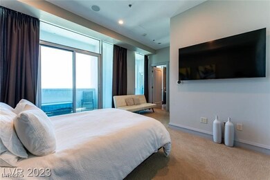 Carpeted bedroom with access to exterior and baseb