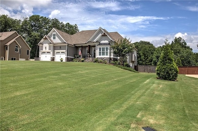 Craftsman house featuring board and batten siding, stone siding, and an attached garage