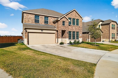 View of front of house with driveway, brick siding, an attached garage, and a shingled roof