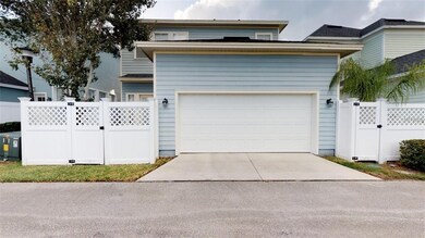 Rear of home, 2 car garage & gated entrance to back yard.