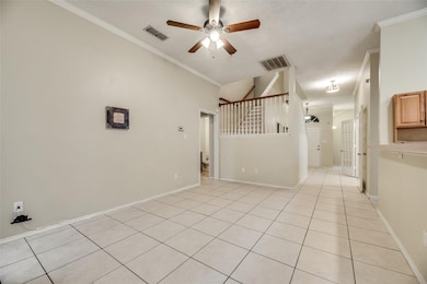 Unfurnished room featuring light tile patterned floors, ornamental molding, and ceiling​​‌​​​​‌​​‌‌​​‌​​​‌‌​​​​​​‌‌‌​​‌​​‌‌​​​‌ fan