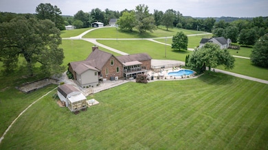 inviting in-ground pool just in time for the hot summer months as well as a greenhouse/potting shed featured in this photo