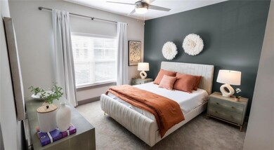 Carpeted bedroom with ceiling fan