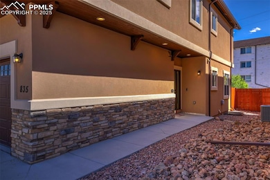 View of property exterior with fence, stone siding