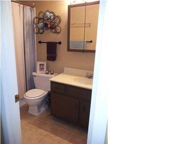 Hall bathroom features tiled floors and full batht