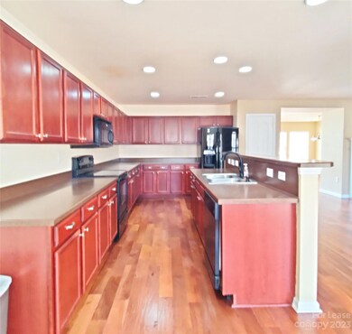 Kitchen with lots of beautiful cherry cabinets and lots of working counterspace