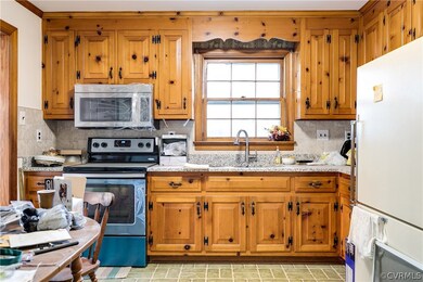 Eat-in kitchen has a few ongoing projects, but has solid original knotty-pine cabinets, new granite countertops, and new ceramic tile backsplash. Just installed new stainless steel oven and microwave!