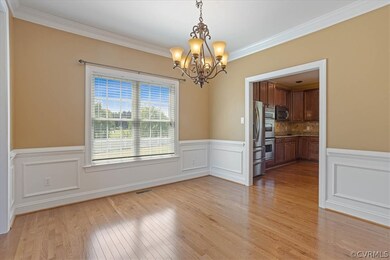 The formal dining room offers crown molding and traditional wainscoting.