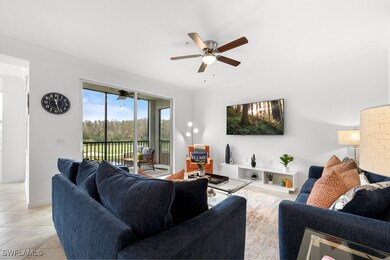 Living area featuring ornamental molding, a ceiling fan, and light tile patterned floors