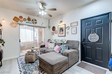 Living room with ceiling fan, wood finished floors