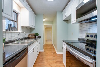 Stainless appliances and tiled back splash welcome you into the kitchen