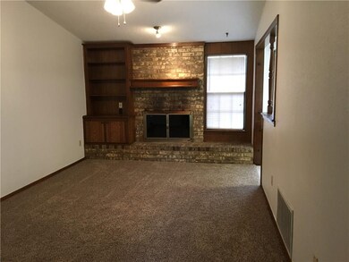 Living room has nice fireplace and built in.