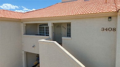 Doorway to property featuring a tile roof and stuc