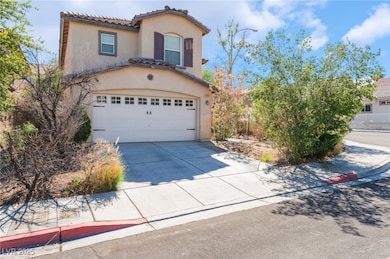 View of front facade with an attached garage, driveway, a tiled roof, and stucco siding