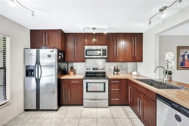 Kitchen featuring backsplash, appliances with stai