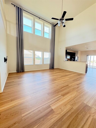 Unfurnished living room with a high ceiling, ligh