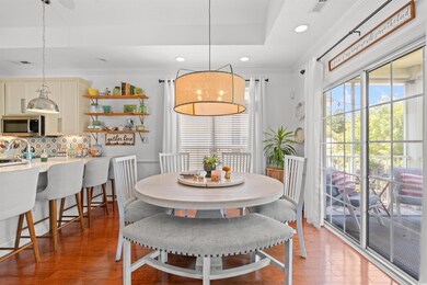 Dining space featuring healthy amount of natural light, light wood-style floors, crown molding, and recessed lighting