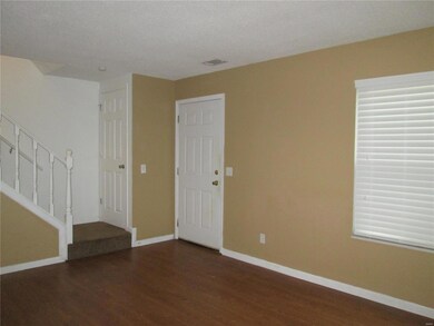 Living room looking at front door and staircase