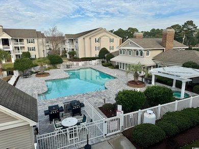Community pool with a fenced backyard, a pergola, area for grilling, and a patio area