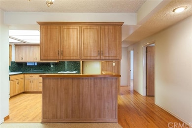 view of kitchen and bar. hallway on right goes to 